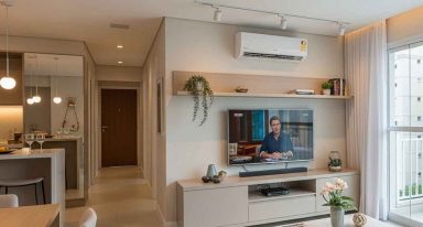 Sala de apartamento com eletrônicos e luzes ligados